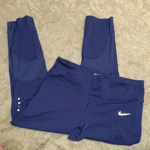 Blue Nike Dri-Fit crop leggings with mesh detail